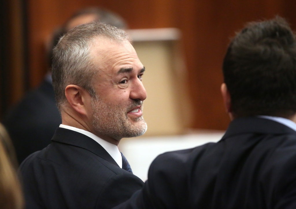 Gawker founder Nick Denton talks with his legal team before Hulk Hogan testifies in Florida court