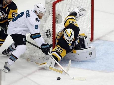 Pittsburgh Penguins goalie Matt Murray pokes the puck away from San Jose Sharks&apos Joe Pavelski during the third period in Game 2 of the NHL hockey Stanley Cup Finals on Wednesday