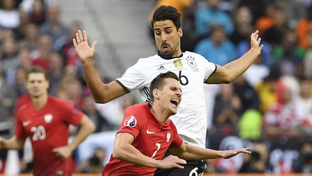 Germany's midfielder Sami Khedira commits a foul on Poland's forward Arkadiusz Milik