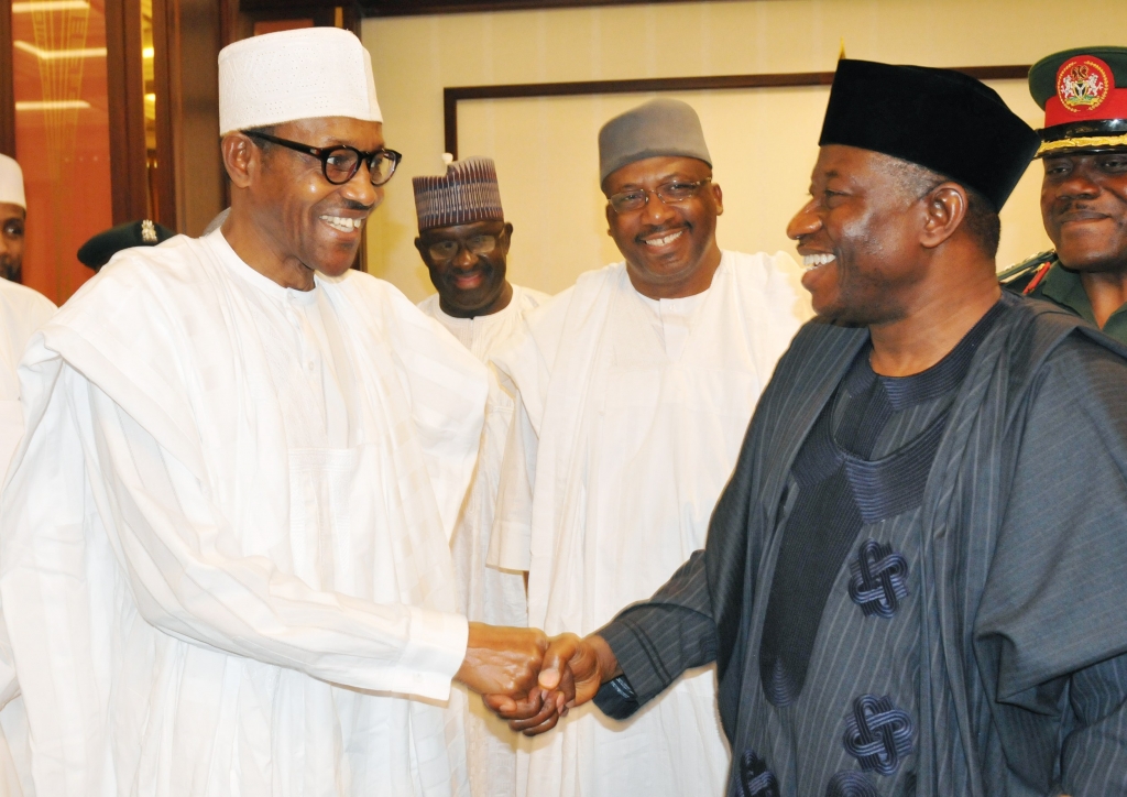 ELECT RETIRED MAJ.-GEN. MUHAMMADU BUHARI IN A HANDSHAKE WITH PRESIDENT GOODLUCK JONATHAN DURING HIS OFFICIAL VISIT TO THE PRESIDENTIAL VILLA IN ABUJA ON FRIDAY.WITH THEM IS THE FORMER CHIEF OF ARMY STAFF,RETIRED LT.-GEN. AB