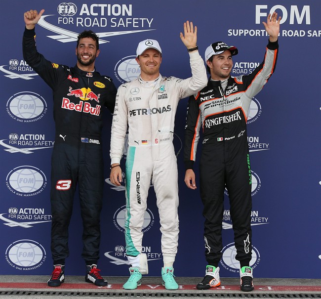 Mercedes driver Nico Rosberg of Germany center pole position flanked by second best time Force India driver Sergio Perez of Mexico right and third best time Red Bull driver Daniel Ricciardo of Australia cheer reporters after the qualifying session