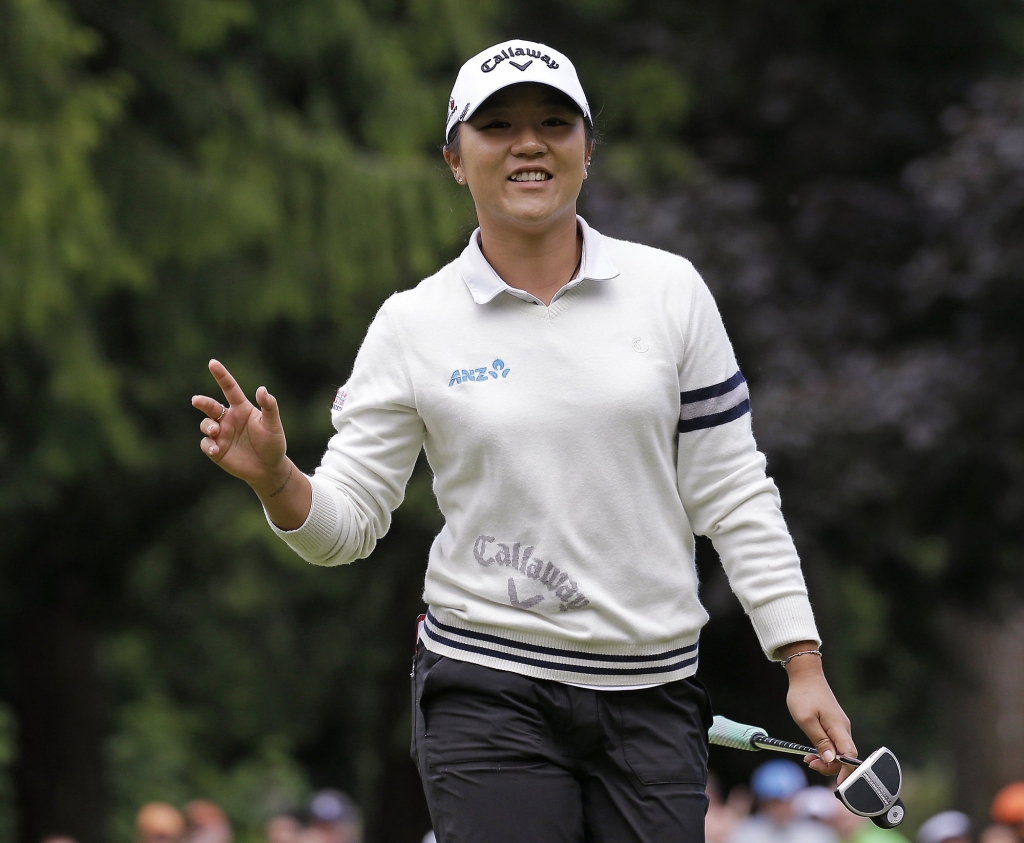 Lydia Ko of New Zealand waves after making a putt on the sixth hole in the third round at the Women's PGA Championship golf tournament at Sahalee Country Club Saturday