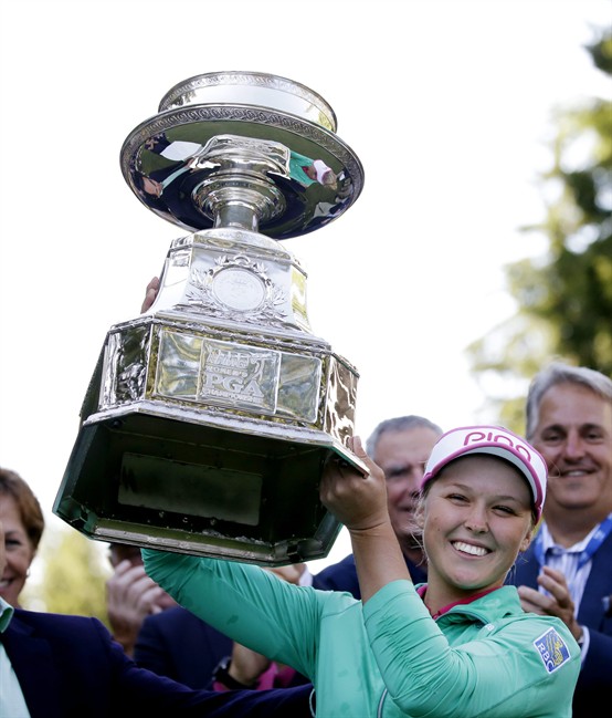 Brooke Henderson of Canada lifts the championship trophy after winning the Women's PGA Championship golf tournament at Sahalee Country Club on Sunday