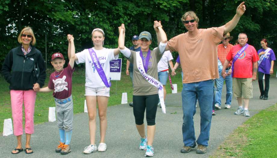 Cancer survivor Valerie Walsh is joined during the American Cancer Society's Relay for Life at Sarah Noble Intermediate School in New Milford by her husband Brian her children Collin and Bailey and Brian's mother