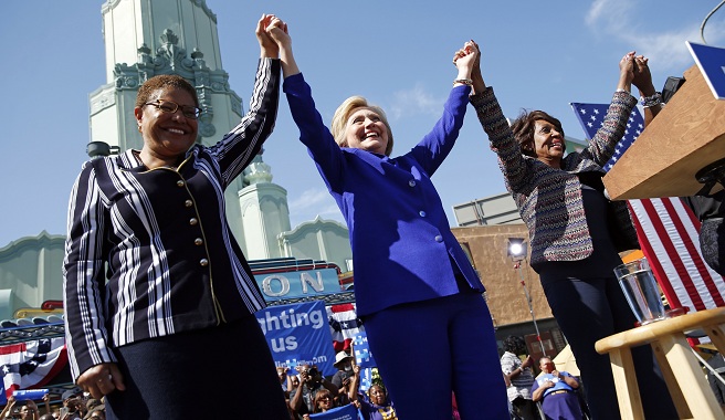 Democratic presidential candidate Hillary Clinton center celebrates at a rally with Rep. Karen Bass D-Calif. left and Rep. Maxine Waters D-Calif. Monday