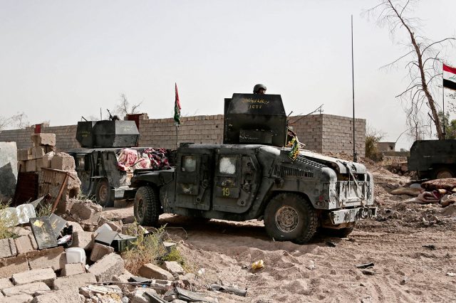 Humvees gather on the edge of the Shuhada neighborhood in Islamic State-held Fallujah on Wednesday. AP