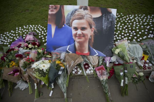 An image and floral tributes for Jo Cox lay on Parliament Square outside the House of Parliament in London on Friday. The 41-year-old British Member of Parliament was fatally injured in an attack on Thursday in northern England