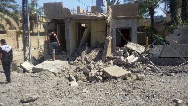 Civilians inspect damage at a home after