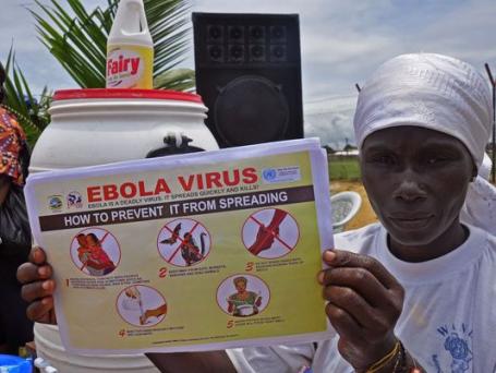 Image Text
 EBOLA-FREE A resident holds up a leaflet explaining how to prevent a further outbreak