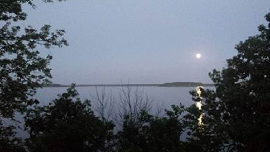 Image of a full moon rising over Oologah Lake earlier this year