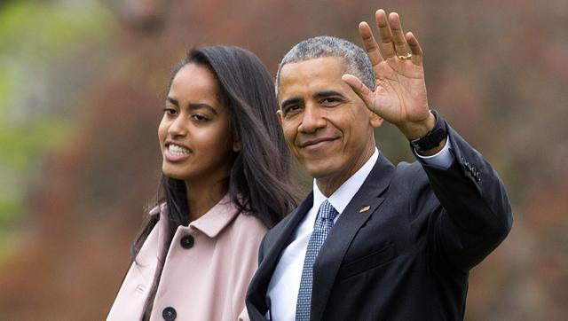 US President Barack Obama and his daughter Malia walk across the South Lawn of the White House in Washington