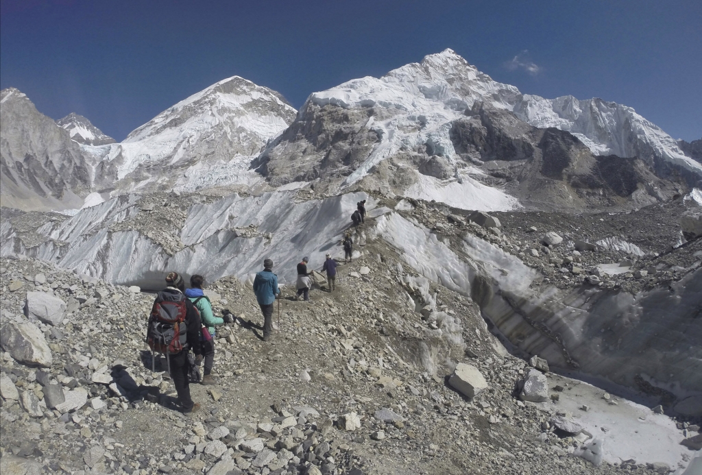 International trekkers pass through a glacier at the Mount Everest base