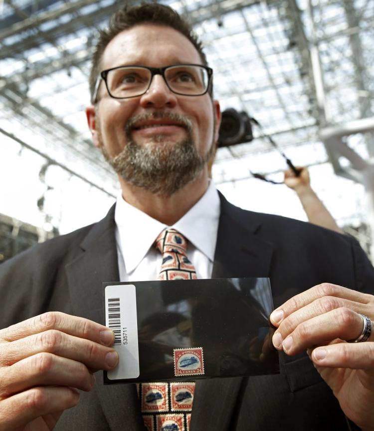 American Philatelic Society executive director Scott D. English holds the'inverted Jenny that was returned to the organization Thursday