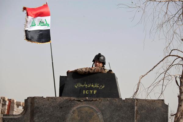 A soldier from Iraq's elite counterterrorism forces looks from the gun turret of a Humvee as troops gather on the edge of the Shuhada neighborhood in Islamic State-held Fallujah Iraq