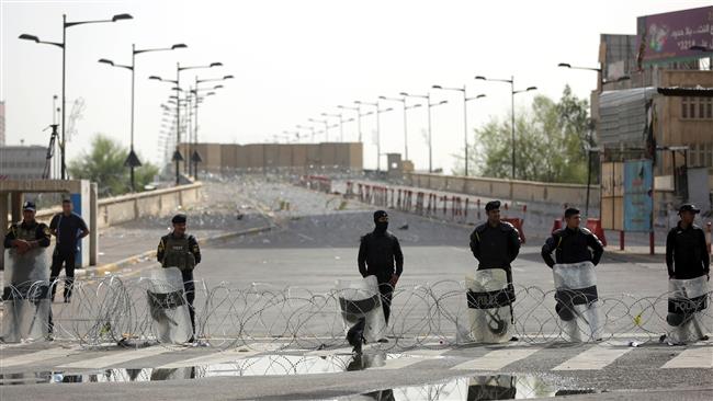 Iraqi riot police stand guard at the Jumhuriyah Bridge a route leading from Tahrir Square to the Green Zone