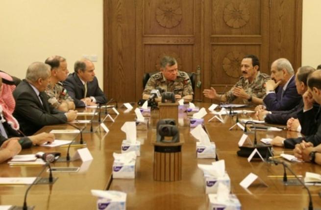 Jordan's King Abdullah II listens to his Military Advisor and Chairman of the Joint Chief-of Staff General Mishal Al Zaben talking during an emergency meeting in the capital Amman after a car bomb