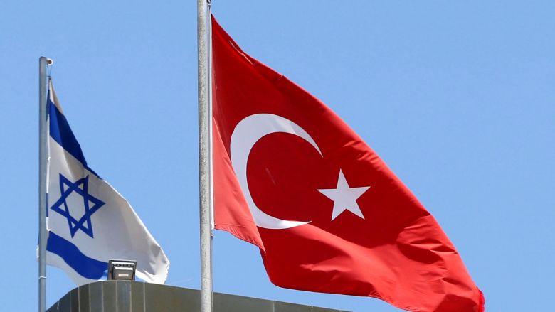 A Turkish flag flutters atop the Turkish embassy as an Israeli flag is seen nearby in Tel Aviv Israel