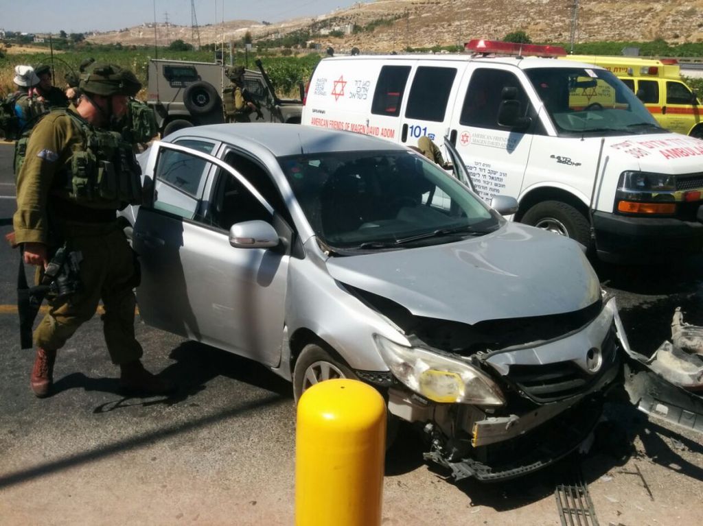 Israeli couple's car after it was struck by another vehicle driven by a Palestinian woman in a possible terror attack at the entrance to Kiryat Arba in the West Bank