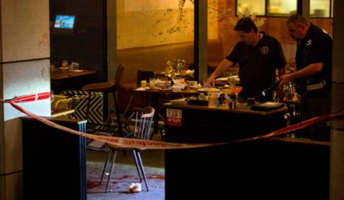 Israeli police officers examine the scene of a shooting attack in Tel Aviv Israel