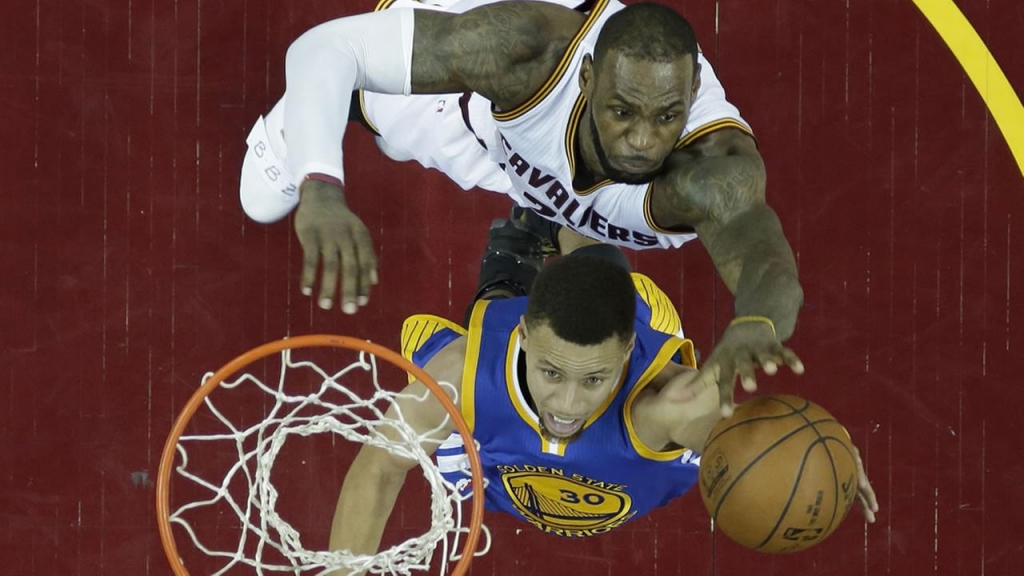 Golden State Warriors Stephen Curry drives to the basket against Cleveland Cavaliers Le Bron James in Game 6 of the NBA basketball Finals Thursday