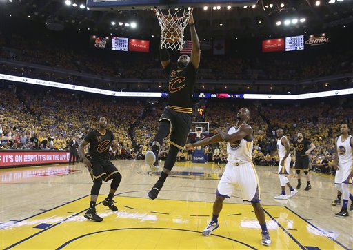 Cleveland Cavaliers forward Le Bron James dunks against the Golden State Warriors during the second half of Game 5 of basketball's NBA Finals in Oakland Calif. Monday