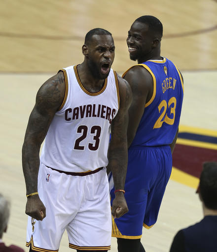 Cleveland Cavaliers forward Le Bron James left reacts as Golden State Warriors forward Draymond Green right looks back during the first half of Game 3 of basketball's NBA Finals in Cleveland Wednesday