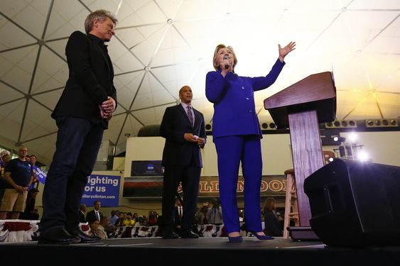 Hillary Clinton stands on stage with musician Bon Jovi left and Sen. Cory Booker D-N.J. while speaking during a campaign stop at the Newark campus of Rutgers University Wednesday