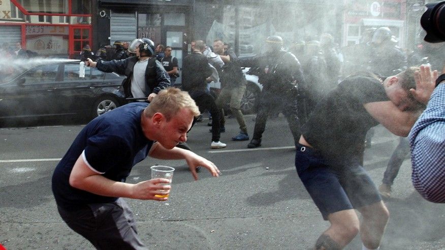 English fans run after getting sprayed with pepper spray by French police during scuffles in downtown Lille northern France