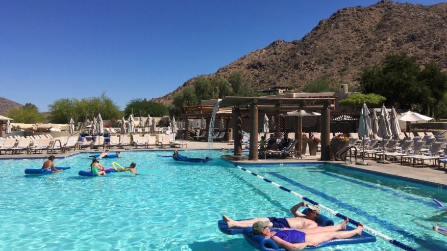 Hotel guests cool off at the pool at the JW Marriott Scottsdale Camelback Inn Resort and Spa in Paradise Valley Ariz