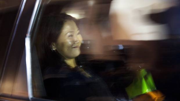 Keiko Fujimori smiles as she is driven from a local campaign house in Lima