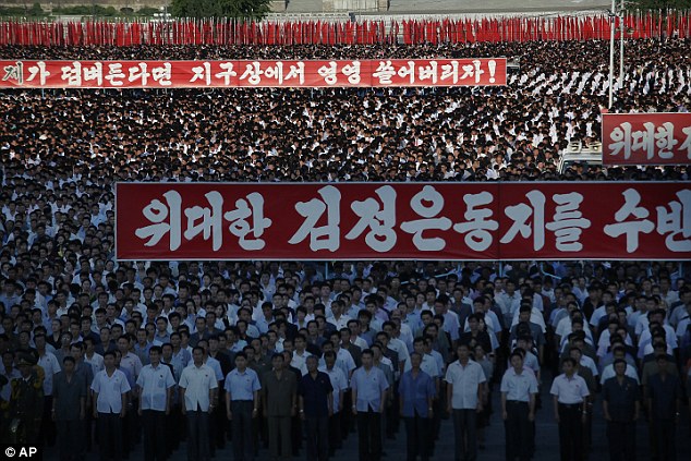 People could be seen carrying propaganda slogans during an anti-U.S. rally attended by thousands of North Koreans to mark the 66th anniversary of the start of the Korean War