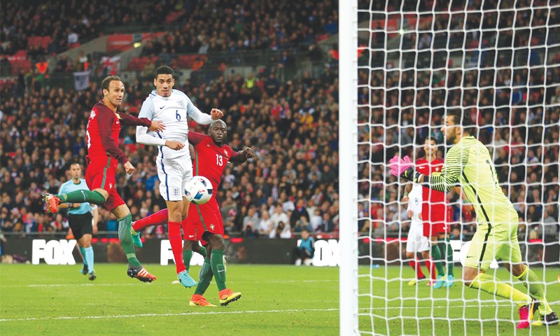 LONDON England’s Chris Smalling heads to score during the international friendly against Portugal at the Wembley Stadium.—AP