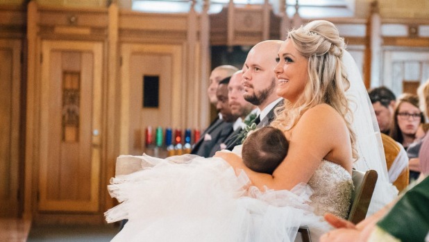 Bride breastfeeds during wedding ceremony