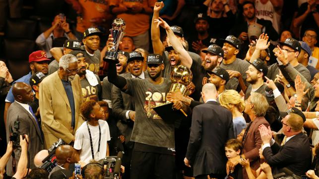 Cleveland Cavaliers forward Le Bron James hoists the Larry O`Brien and the Finals MVP trophies after defeating the Golden State Warriors to win the NBA Finals on Sunday in Oakland California. AFP