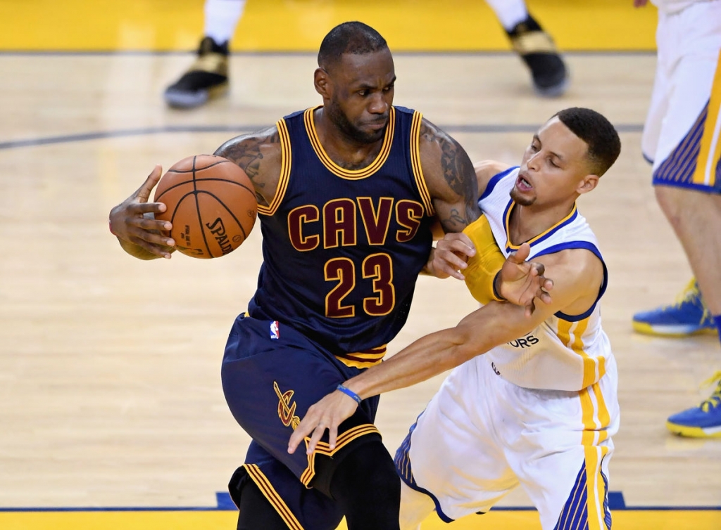 LeBron James attempts to drive past Stephen Curry during Game 1 of the N.B.A. Finals