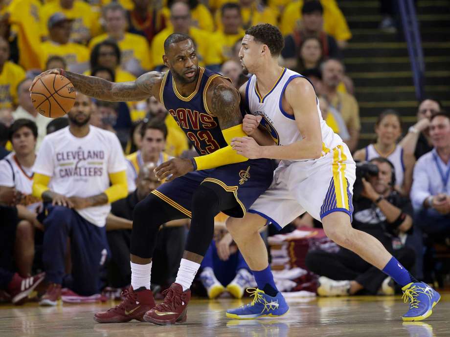 Cleveland Cavaliers forward Le Bron James dribbles against Golden State Warriors guard Klay Thompson during the first half of Game 1 of basketball's NBA Finals in Oakland Calif. Thursday