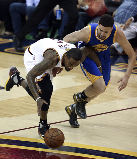 Cleveland Cavaliers forward Le Bron James passes after getting to a loose ball against the Golden State Warriors during the first half of Game 3 of basketball's NBA Finals in Cleveland Wednesday