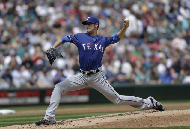 Texas Rangers starting pitcher Cole Hamels works against the Seattle Mariners during the first inning a baseball game Sunday