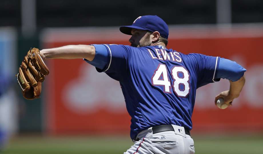 Texas Rangers pitcher Colby Lewis works against the Oakland Athletics in the first inning of a baseball game Thursday