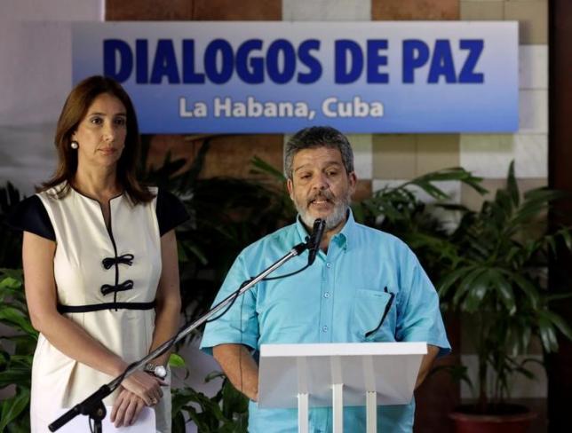 Revolutionary Armed Forces of Colombia negotiator Marcos Carratala reads a document next to Colombian government spokeswoman Marcela Duran in Havana Cuba