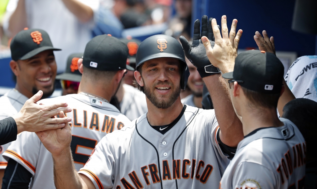 Jun 2 2016 Atlanta GA USA San Francisco Giants starting pitcher Madison Bumgarner celebrates his two-run home run with teammates in the dugout in the 5th inning of their game against the Atlanta Braves at Turner Field. Mandatory Credit Jason Ge