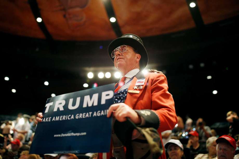 Gregg Donovan holds up a sign before a rally with Republican presidential candidate Donald Trump at the Treasure Island hotel and casino Saturday