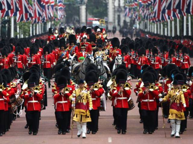 Britain's Queen Elizabeth II returns to Buckingham Palace along the Mall after watching the Queen's Birthday Parade 'Trooping the Colour&#039, in London