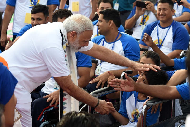 Indian Prime Minister Narendra Modi meets disabled yoga practitioners during a mass yoga session to mark International Yoga Day at Capitol Complex in Chandigarh