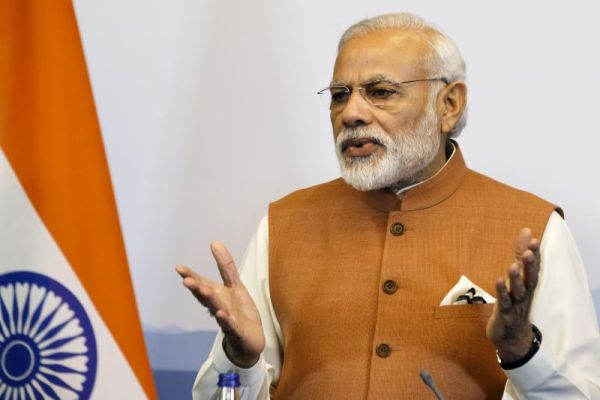 Indian Prime Minister Narendra Modi left speaks during