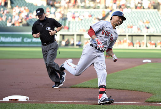 Boston Red Sox Mookie Betts reacts as he rounds third after he hit a home run during the first inning of a baseball game against the Baltimore Orioles Wednesday