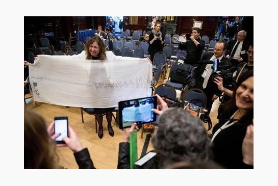 2016 Laser Interferometer Gravitational Wave Observatory Scientific Collaboration Spokesperson Gabriela Gonzalez holds up a scarf depicting gravitational waves for