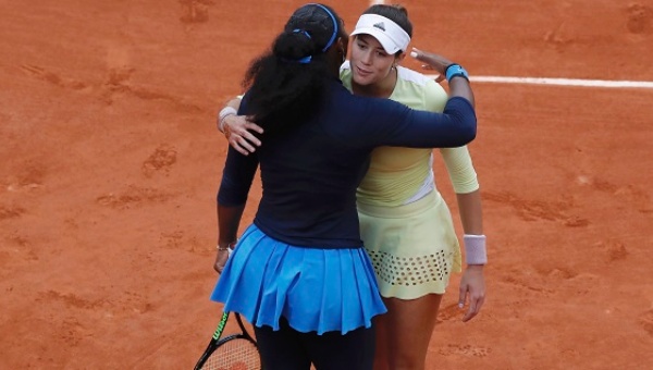 Muguruza hugs Williams at the end of their match