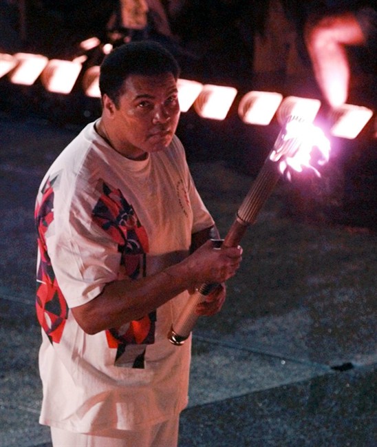 Muhammad Ali watches as the flame climbs up to the Olympic torch during the opening ceremonies of the Summer Olympics in Atlanta. Ali the magnificent heavyweight champion whose fast fists and irrepressible perso