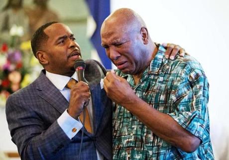 Muhammad Ali’s brother Rahaman wept and was embraced by the Rev. Charles Elliott III during a service Sunday at King Solomon Missionary Baptist Church where their father worshipped in Louisville